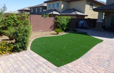 turf grass and pavers overgrown bushes landscaping