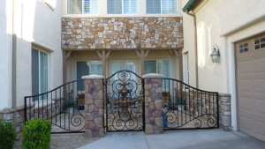 stone feature elements and wrought iron gate and fence for courtyard