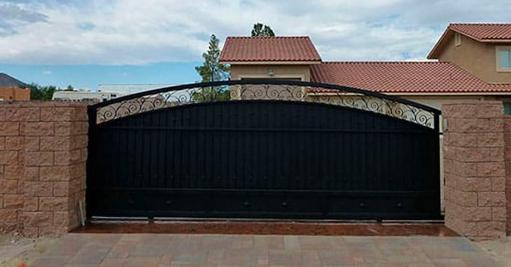 upgrading your entrance gates, custom-designed iron sliding gate in front of a luxury home in las vegas, made by J or J Welder